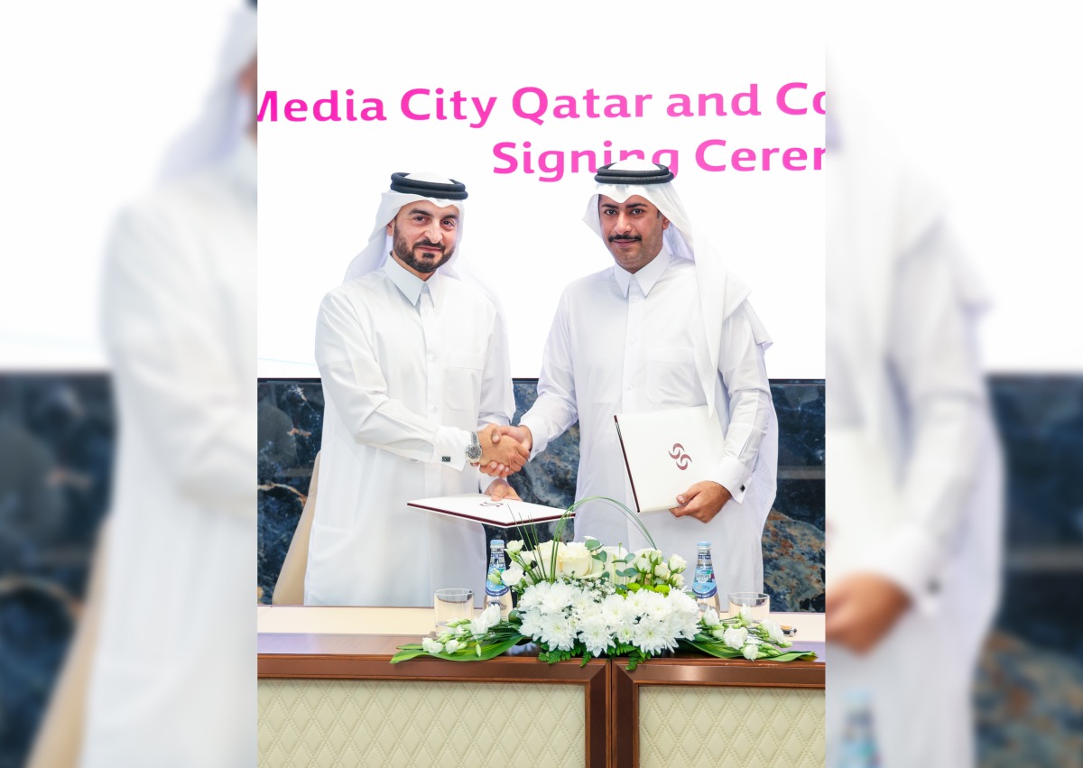 CEO of Media City Qatar Eng. Jassim Mohamed Al Khori with an official of Commercial Bank during the agreement signing. 
