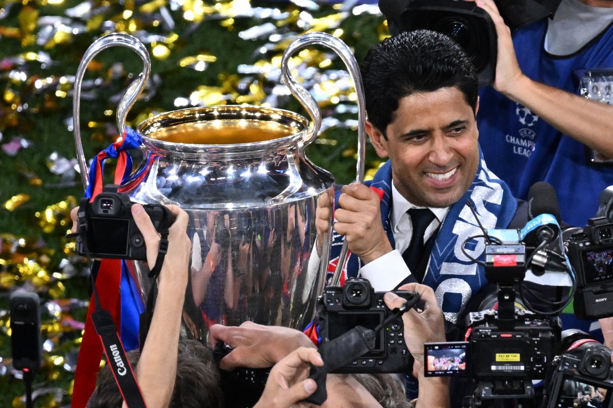 Paris Saint Germain’s President Nasser Al Khelaifi holds the trophy after the club won the UEFA Champions League title, in this May 31 file photo.