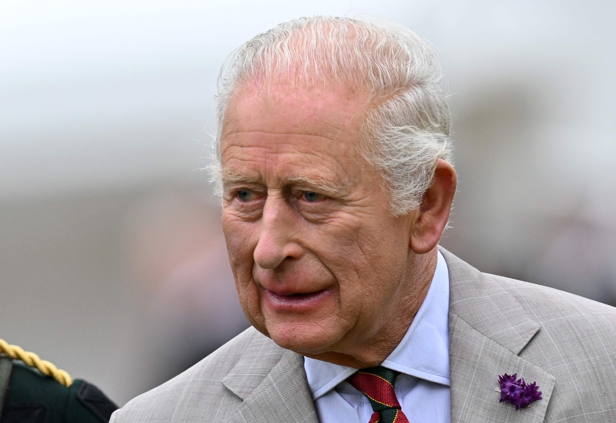 Britain's King Charles III talks with a Member of Royal Company of Archers during the traditional Ceremony of the Keys in the Gardens of the Palace of Holyroodhouse in Edinburgh, Scotland on July 1, 2025, on the first day of their Majesties The King and Queen's visit to Scotland. (Photo by ANDY BUCHANAN / AFP)
