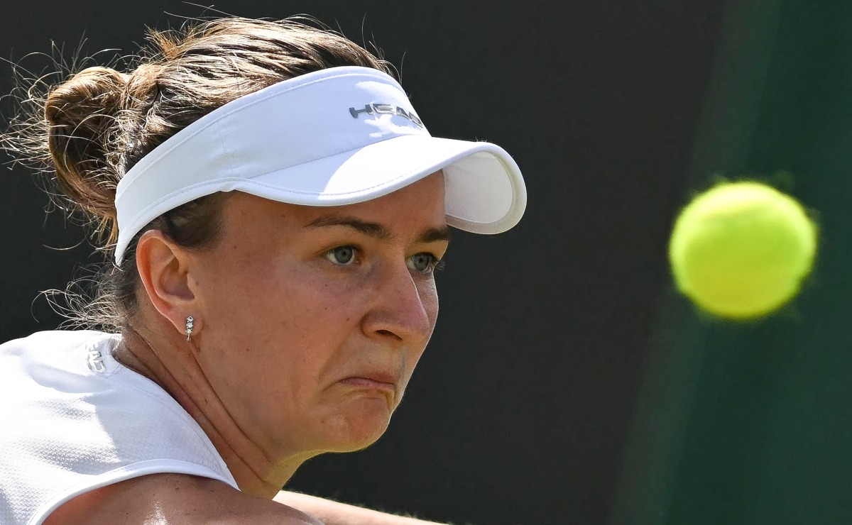 Czech Republic's Barbora Krejcikova eyes the ball as she plays against US player Caroline Dolehide during their women's singles second round tennis match on the fourth day of the 2025 Wimbledon Championships at The All England Lawn Tennis and Croquet Club in Wimbledon, southwest London, on July 3, 2025. (Photo by Glyn KIRK / AFP) / RESTRICTED TO EDITORIAL USE
