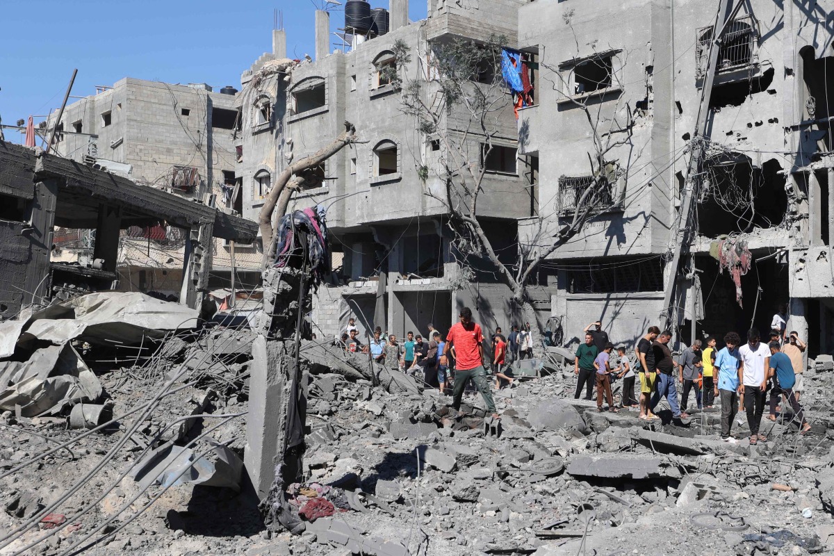 Palestinians inspect the damage after an Israeli strike in the Al-Bureij camp in the central Gaza Strip on July 4, 2025. (Photo by Eyad BABA / AFP)
