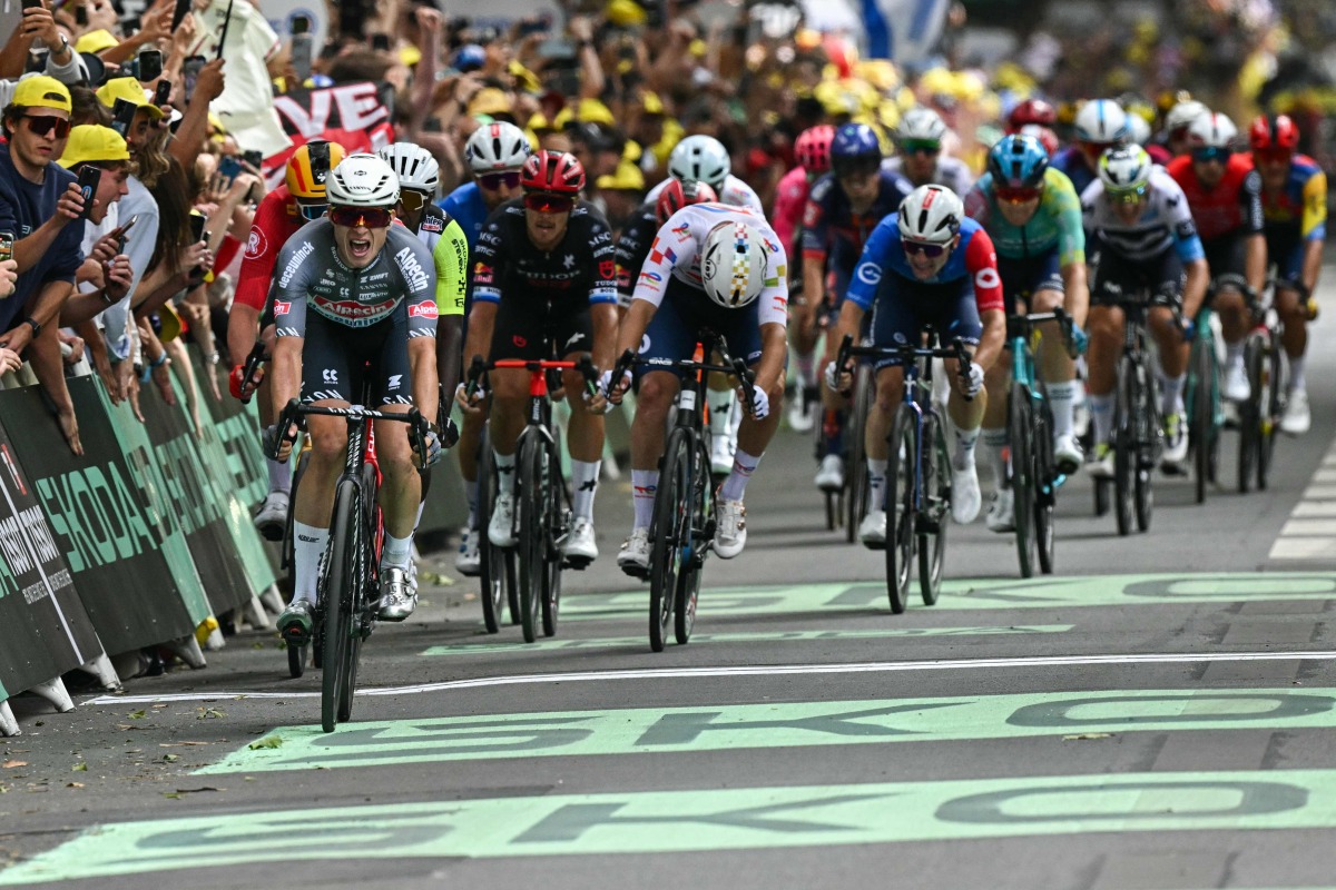 Deceuninck team’s Belgian rider Jasper Philipsen sprints to the finish line to win the 1st stage.