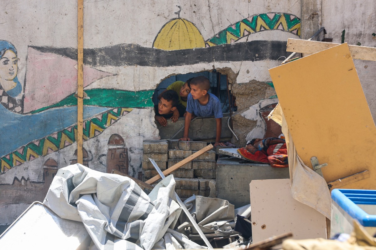 Children check the destruction at Mustafa Hafez school, sheltering Palestinians displaced by the war, after the school was hit during an overnight Israeli strike in Gaza City, on July 3, 2025. Photo by Omar AL-QATTAA / AFP
