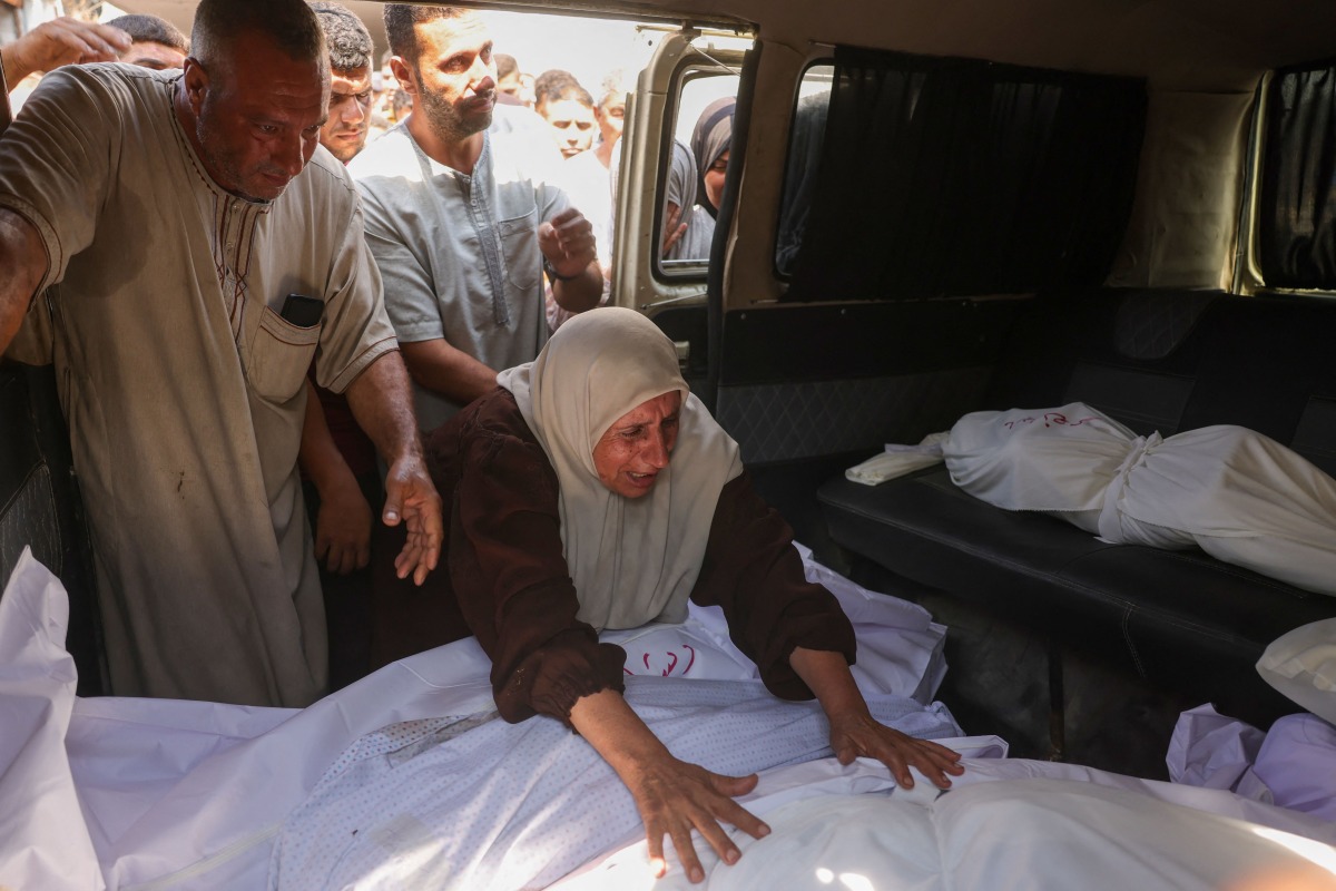 A Palestinian woman mourns a relative, killed in an overnight Israeli strike on a school, during a funeral in Jabalia in the northern Gaza Strip on July 11, 2025. (Photo by BASHAR TALEB / AFP)