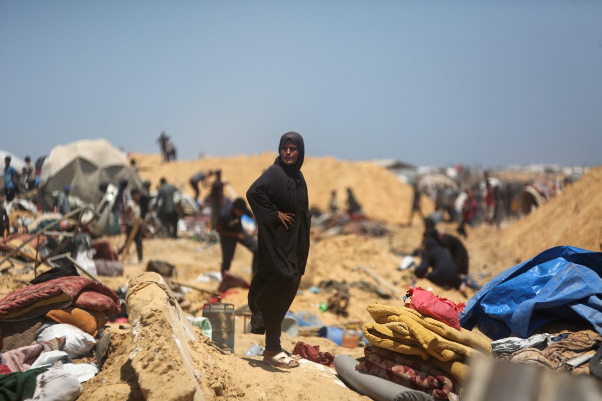 Palestinians inspect the destruction at a makeshift displacement camp following a reported incursion a day earlier by Israeli tanks in the area in Khan Yunis in the southern Gaza strip on July 11, 2025. (Photo by AFP)