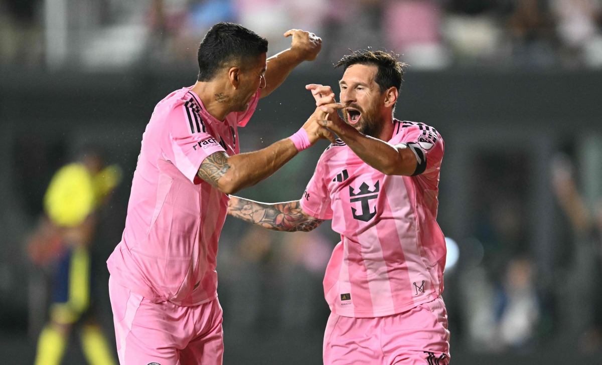 Inter Miami's Argentine forward #10 Lionel Messi (R) celebrates with Inter Miami's Uruguayan forward #09 Luis Suarez after scoring his team's second goal during the Major League Soccer (MLS) regular season soccer match between Inter Miami CF and Nashville SC at Chase Stadium in Fort Lauderdale, Florida on July 12, 2025. (Photo by CHANDAN KHANNA / AFP) 