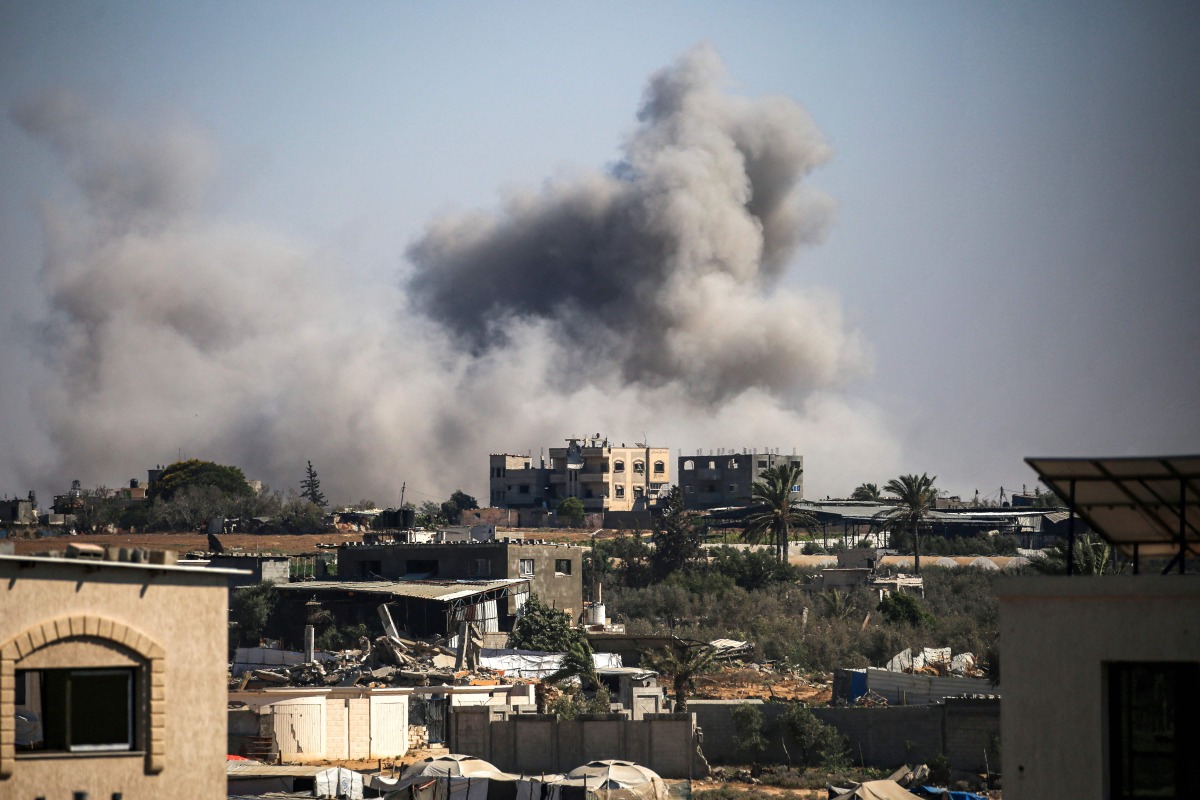 Smoke plumes rise from Israeli bombardment in Bureij in the central Gaza Strip on July 13, 2025. (Photo by Eyad BABA / AFP)
