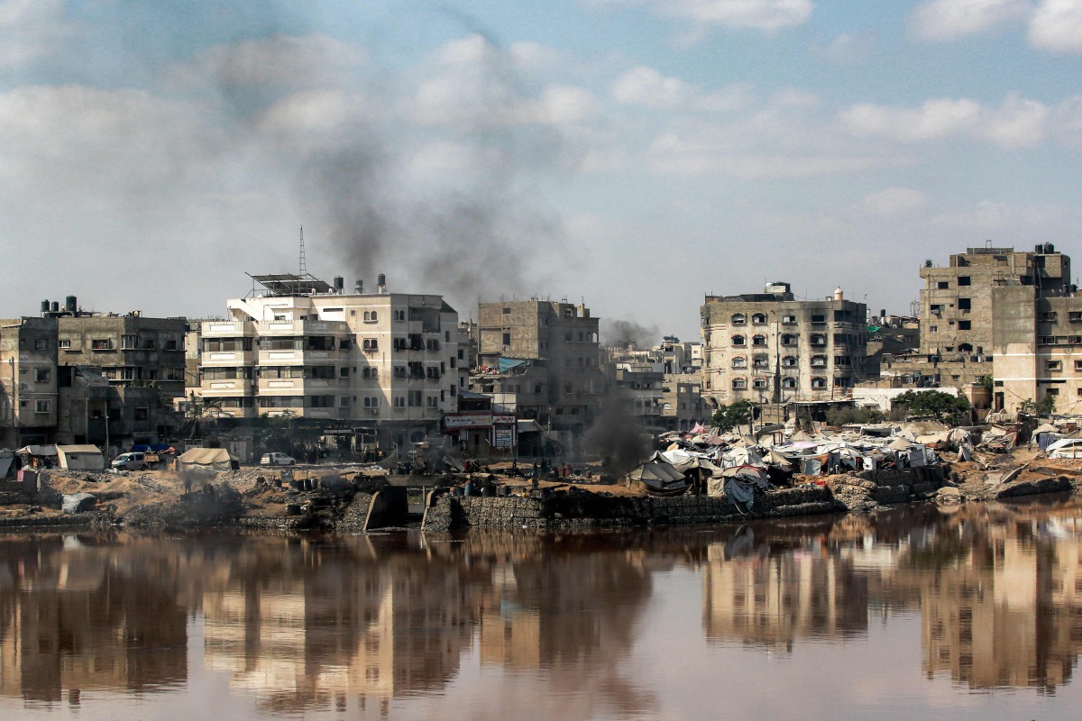 Encampments sheltering Palestinians displaced by conflict are pitched near the Sheikh Radwan wastewater collection pond, which is nearing its filling capacity, in Gaza City on July 14, 2025. (Photo by Bashar TALEB / AFP)