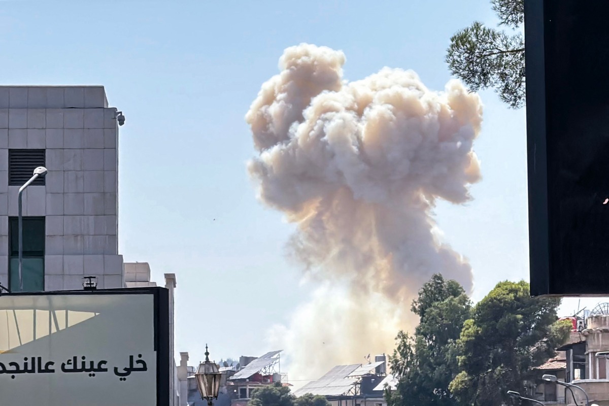 Smoke billows following Israeli strikes near the Syrian army and defence ministry headquarters in Damascus on July 16, 2025. (Photo by Rami al SAYED / AFP)