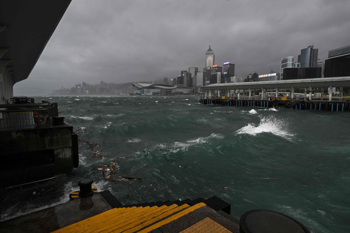 Dark clouds gather and rough seas are seen in Victoria harbour as the typhoon signal number 10 is hoisted as Typhoon Wipha moves towards Hong Kong on July 20, 2025. (Photo by Peter PARKS / AFP)