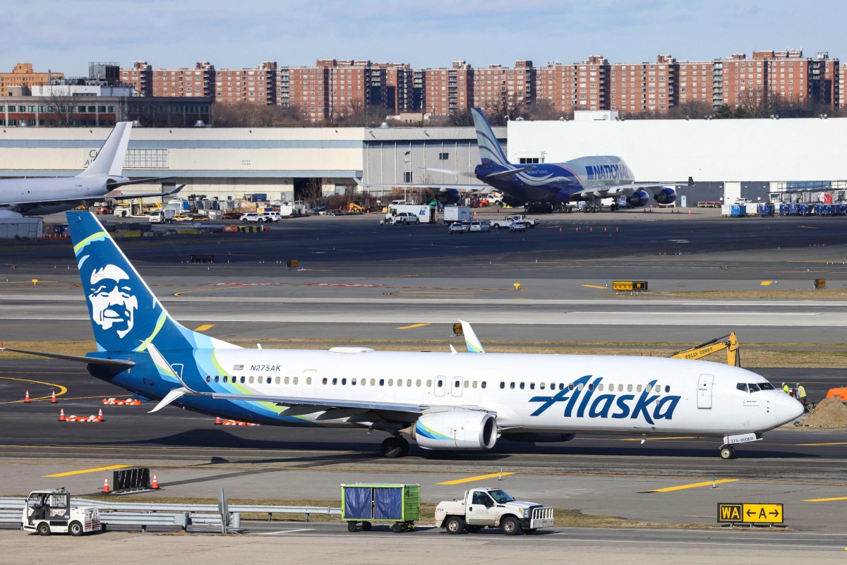 A Boeing 737-900er passengers aircraft of Alaska Airlines on its way to San Francisco is seen before take-off at John F. Kennedy Airport on January 8, 2024. Photo by Charly TRIBALLEAU / AFP