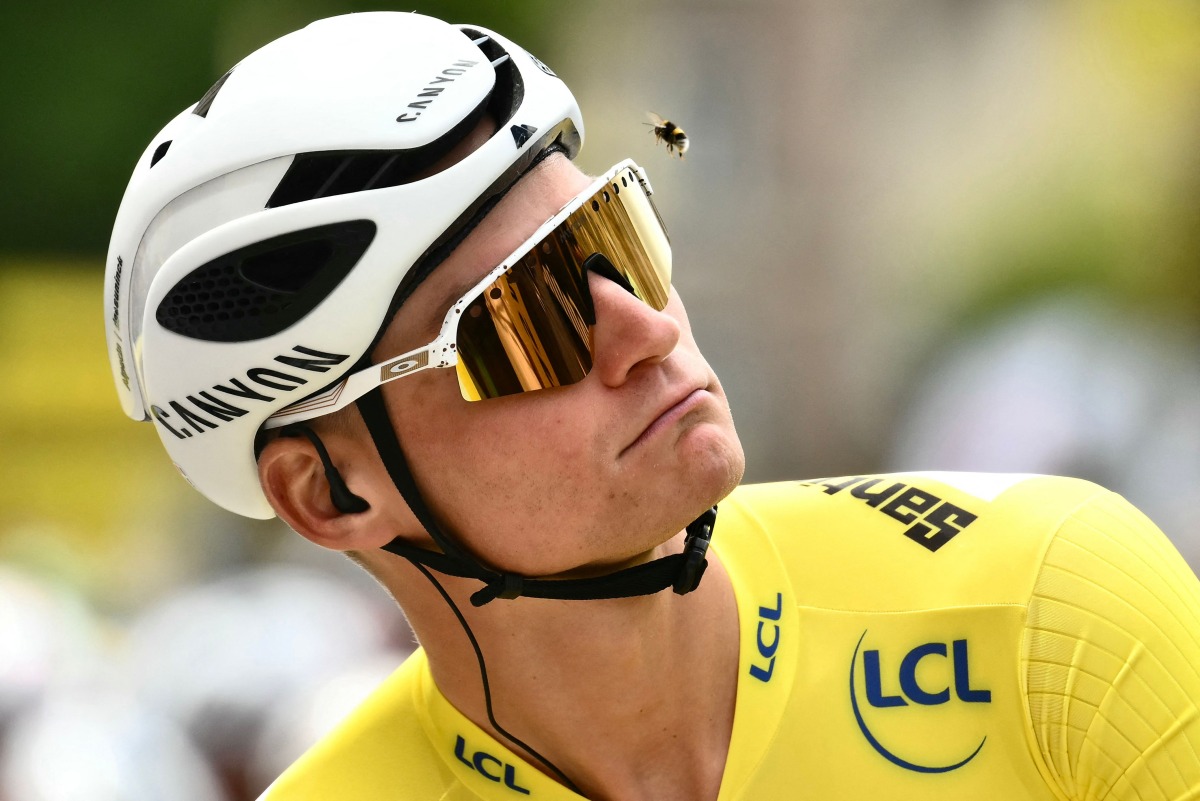 Alpecin - Deceuninck team's Dutch rider Mathieu van der Poel wearing the overall leader's yellow jersey eyes a bee flying past his head at the start of the 4th stage of the 112th edition of the Tour de France cycling race, 174.2 km between Amiens Metropole and Rouen, Northern France, on July 8, 2025. Photo by Marco BERTORELLO / AFP
