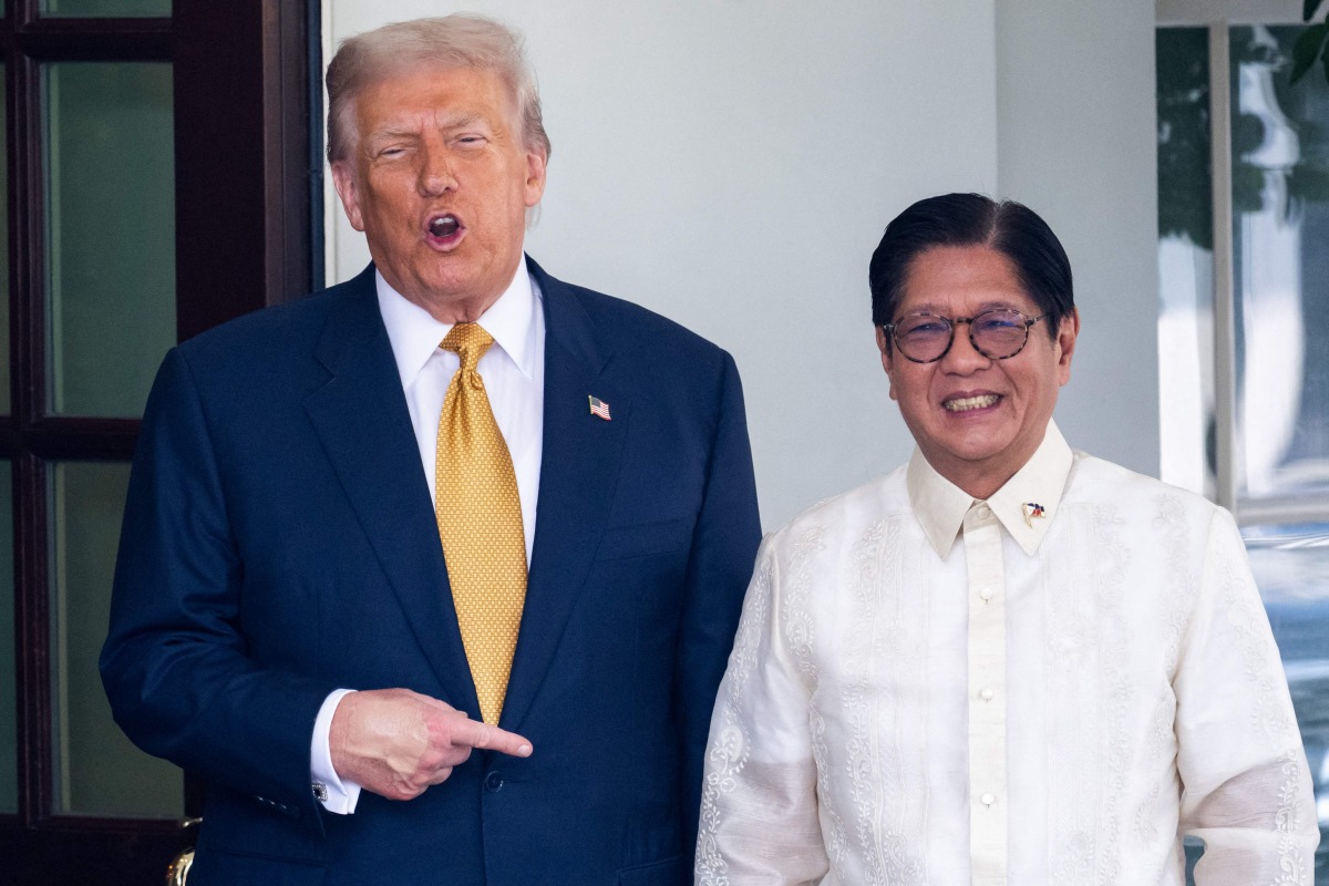US President Donald Trump welcomes Filipino President Ferdinand Marcos Jr. at the entrance to the West Wing of the White House in Washington, DC on July 22, 2025. (Photo by SAUL LOEB / AFP)
