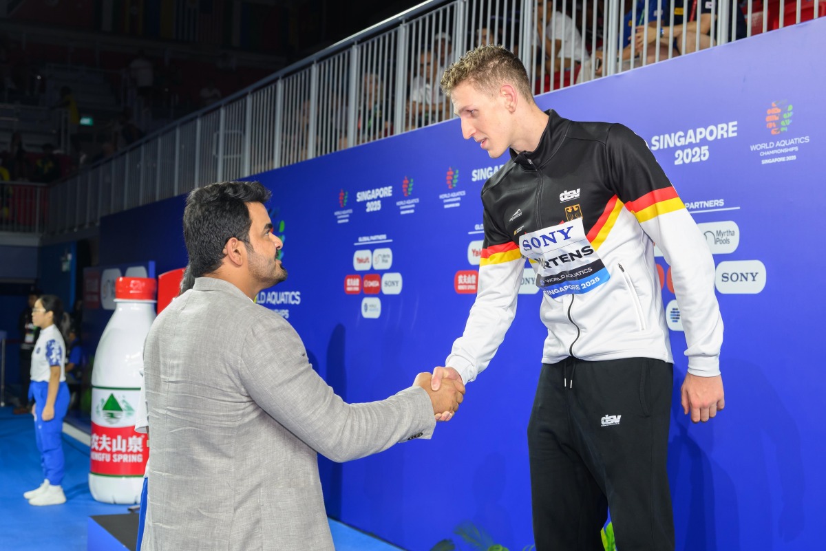 Qatar Olympic Committee President H E Sheikh Joaan bin Hamad Al Thani shakes hands with the men’s 400m freestyle gold medallist Lukas Maertens of Germany.