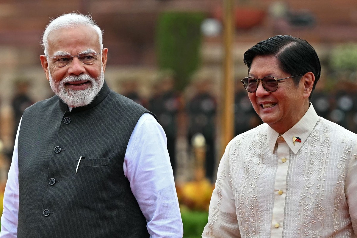 Philippine President Ferdinand Marcos (R) listens to India's Prime Minister Narendra Modi during the ceremonial reception at India's presidential palace Rashtrapati Bhavan in New Delhi on August 5, 2025.Photo by Sajjad HUSSAIN / AFP
