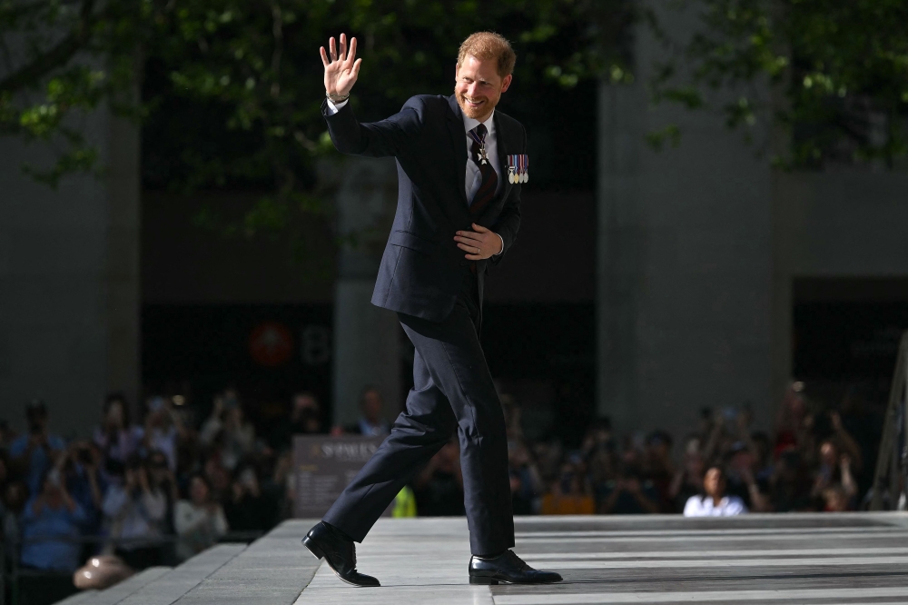(Files) Britain's Prince Harry, Duke of Sussex waves as he arrives to attend a ceremony marking the 10th anniversary of the Invictus Games, in central London, on May 8, 2024. (Photo by Justin Tallis / AFP)

