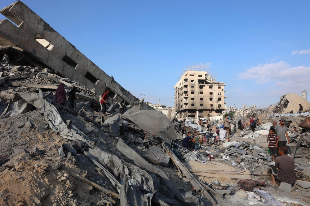 Palestinians inspect the damage after an overnight strike on the Sheikh Radwan Health Centre in the north of Gaza City on August 6, 2025. (Photo by Omar Al-Qattaa / AFP)