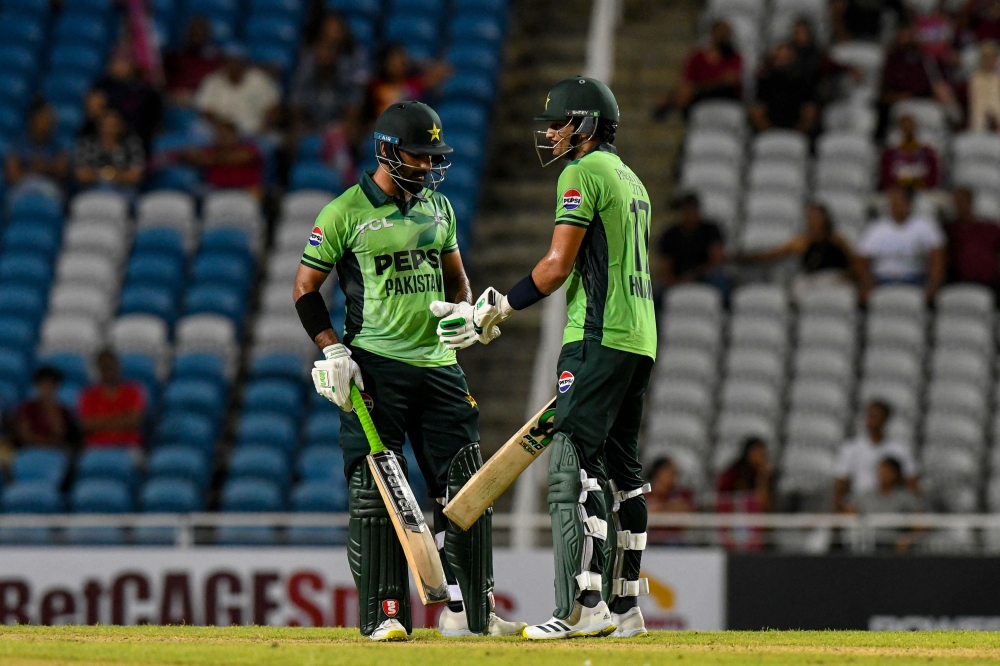 Hasan Nawaz (L) and Hussain Talat (R) of Pakistan celebrate a 100-run partnership during the ODI cricket match between West Indies and Pakistan on August 8, 2025. (Photo by Randy Brooks / AFP)
 