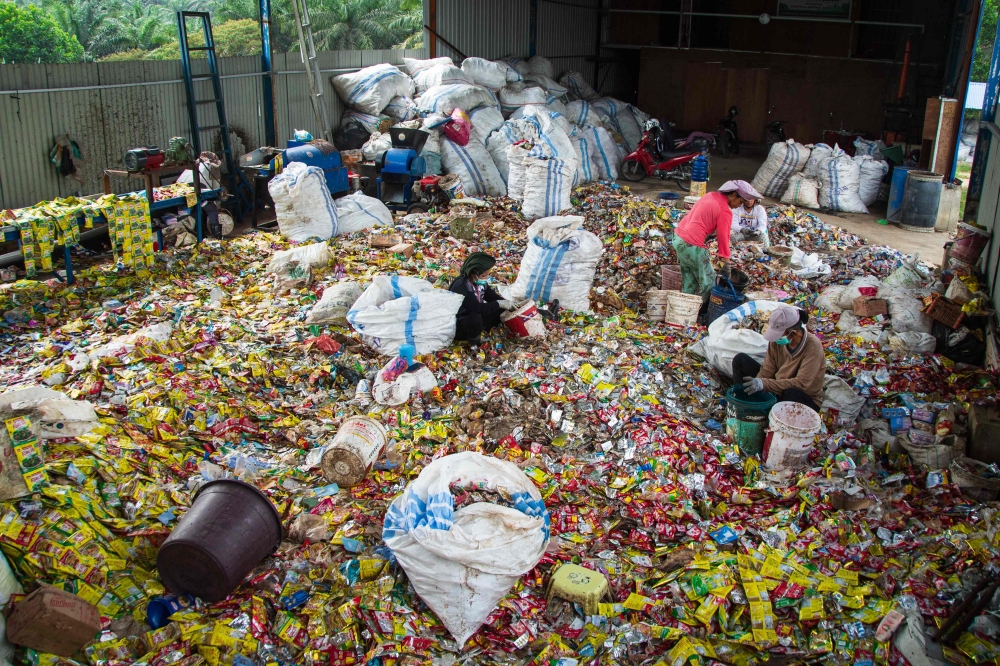 Women sort plastic waste at a workshop in Pekanbaru, Riau, on August 8, 2025. (Photo by Wahyudi / AFP)