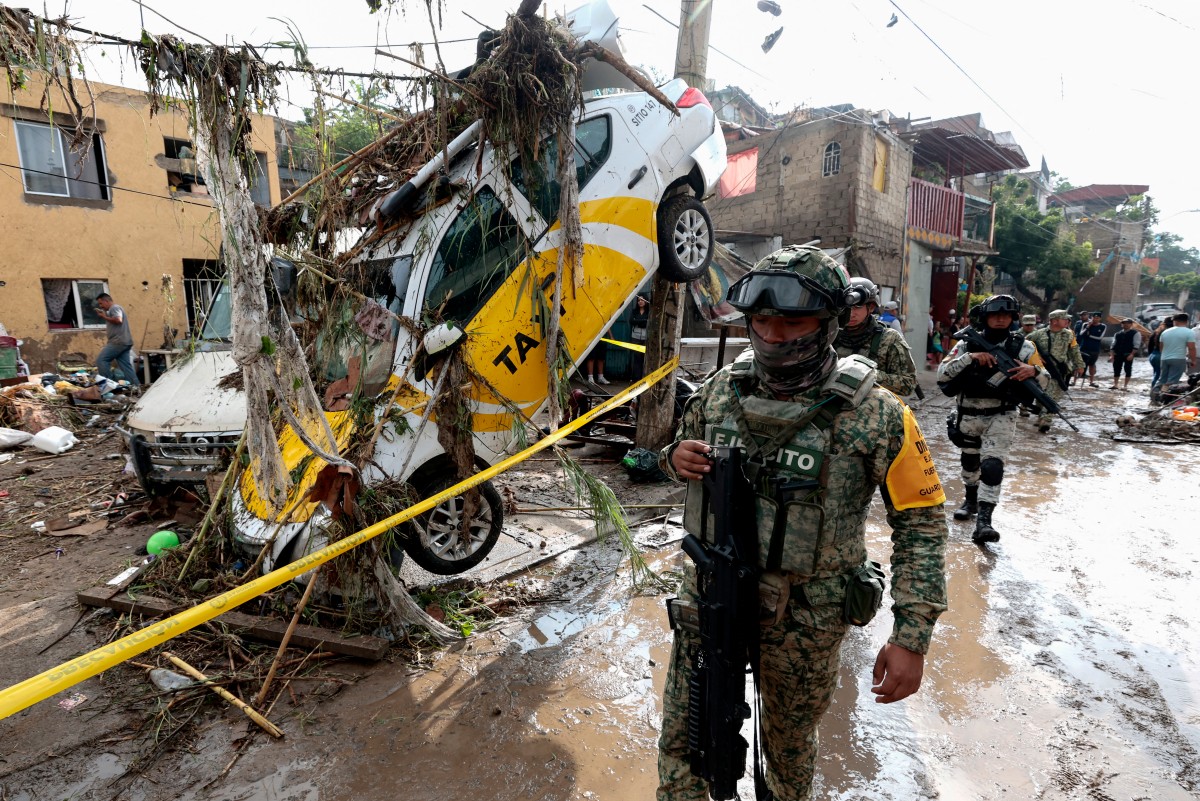 (Files) Army soldiers patrol the area affected by flash flooding due to heavy rains in Zapopan, Jalisco state, Mexico on July 16, 2025. (Photo by ULISES RUIZ / AFP)