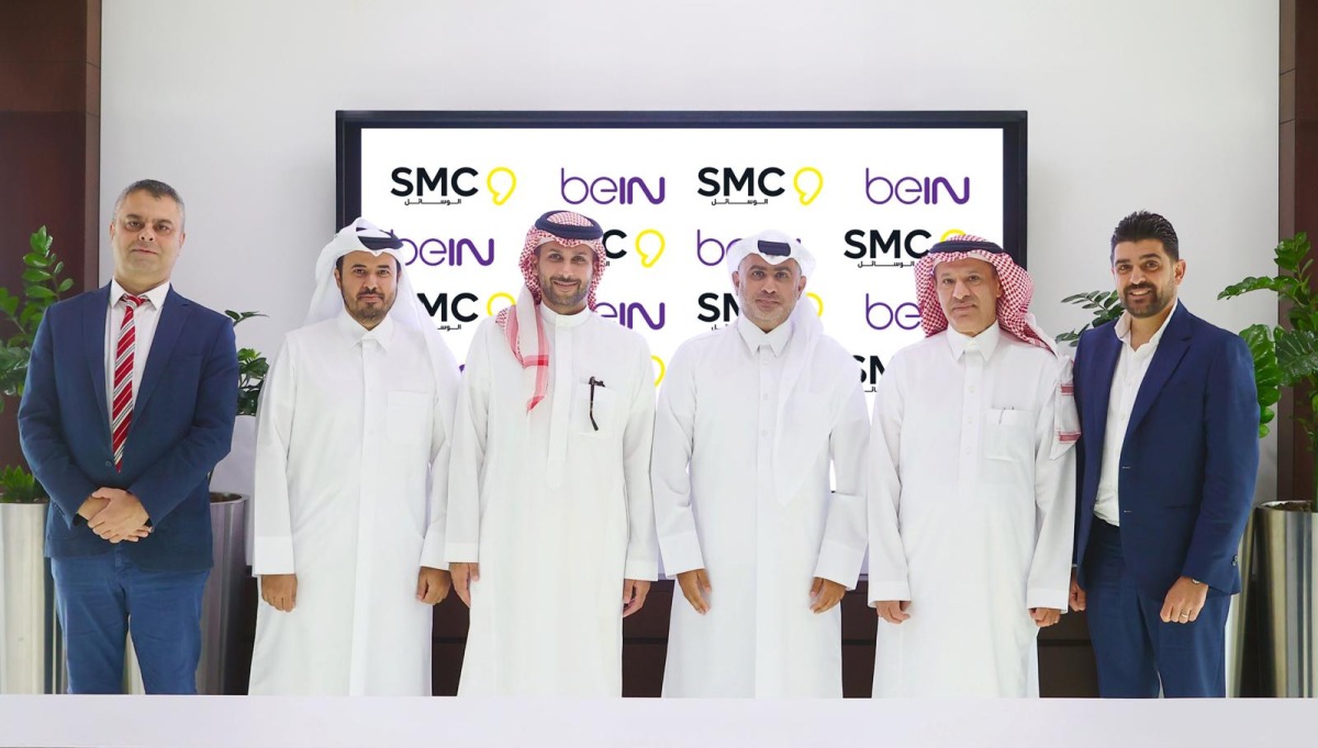 beIN and SMC officials in a group photo during the agreement signing ceremony.
