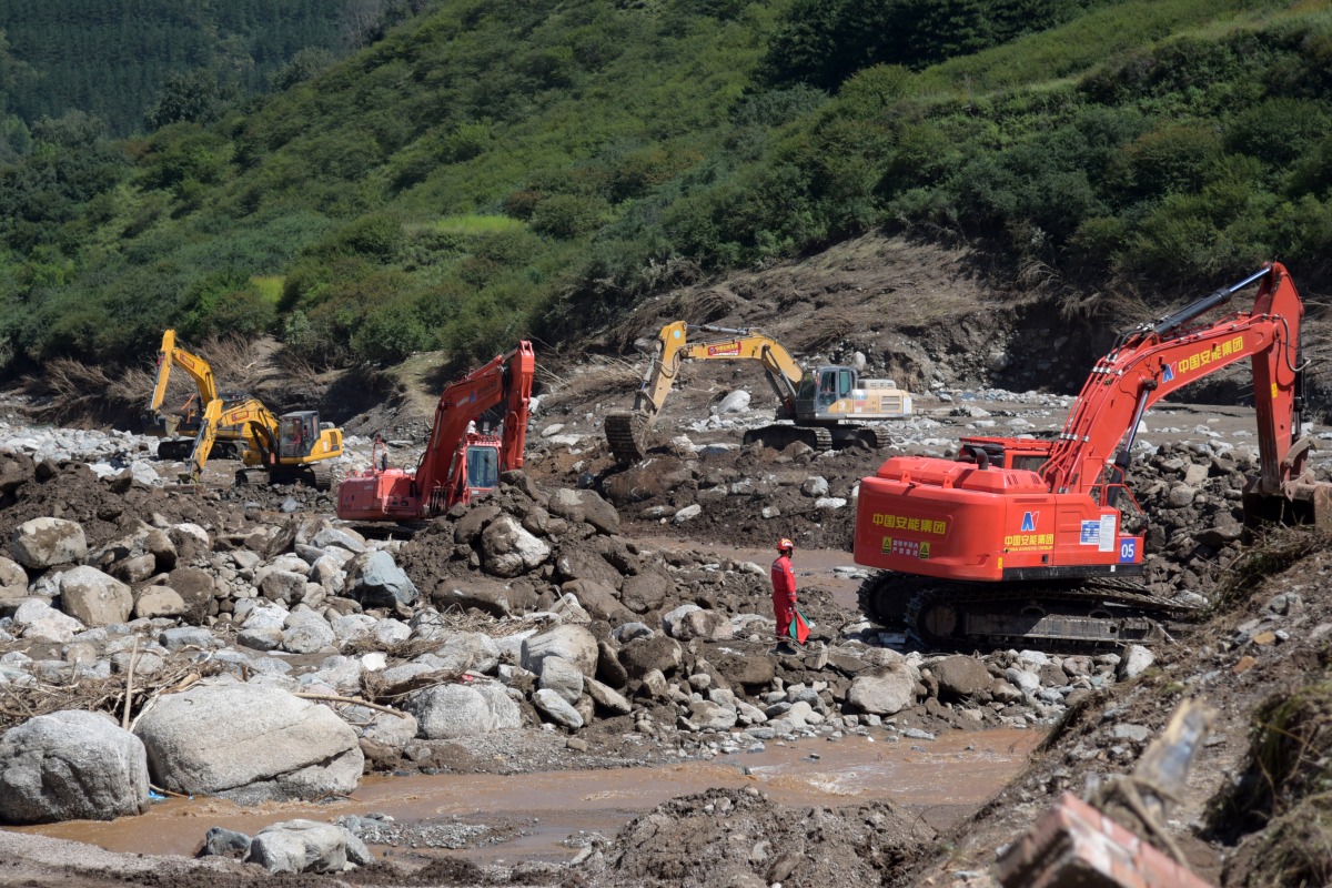Rescuers clear rocks following flash floods in Yangwashan Village, Yuzhong County of northwest China's Gansu Province, Aug. 11, 2025. (Xinhua/Fan Peishen)