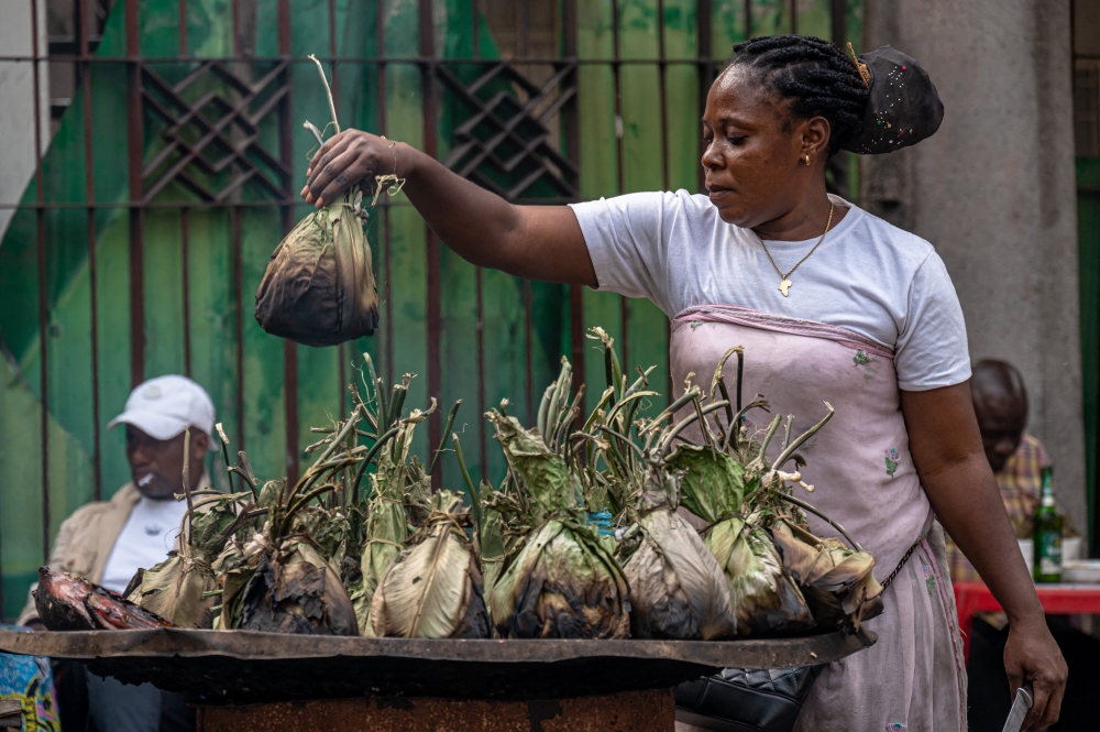 A vendor grills liboke in Kinshasa on August 7, 2025. (Photo by Hardy Bope / AFP)