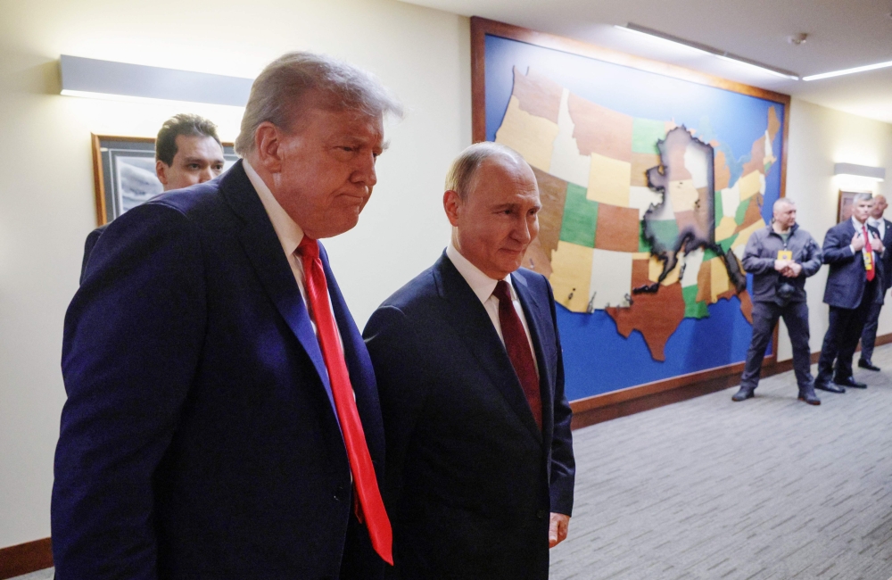 In this pool photograph distributed by the Russian state agency Sputnik, US President Donald Trump (L) and Russian President Vladimir Putin (R) walk to hold a joint press conference following a US-Russia summit on Ukraine at Joint Base Elmendorf-Richardson in Anchorage, Alaska, on August 15, 2025. (Photo by Gavriil GRIGOROV / POOL / AFP)
 