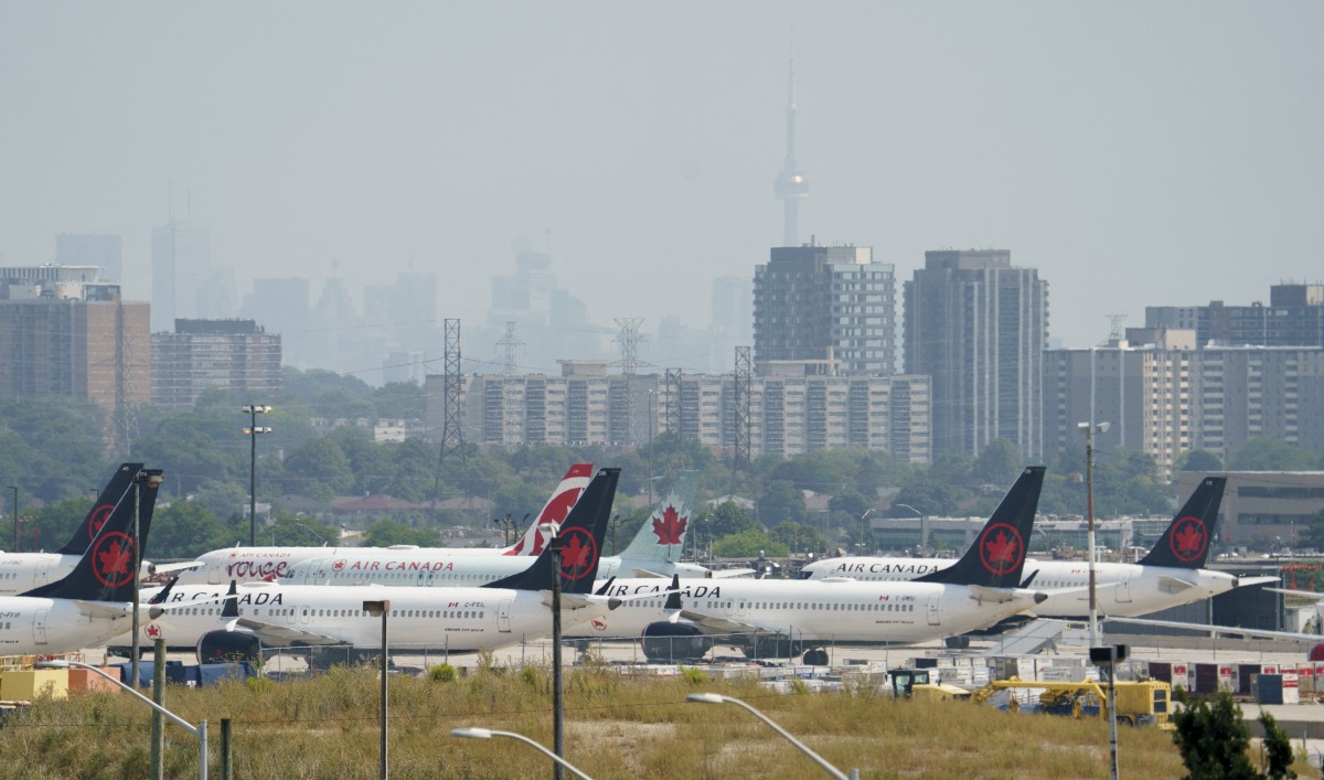 Air Canada airplanes stand on the tarmac at Pearson International Airport in Toronto on August 16, 2025. Photo by Peter POWER / AFP.
