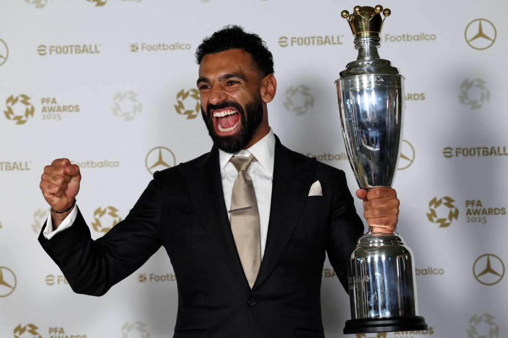 Liverpool's Egyptian striker Mohamed Salah poses with the Men's PFA Players' Player of the Year award backstage during the 2024-2025 Professional Footballers' Association (PFA) awards, at the Opera House in Manchester, northern England, on August 19, 2025. (Photo by Darren Staples / AFP)
