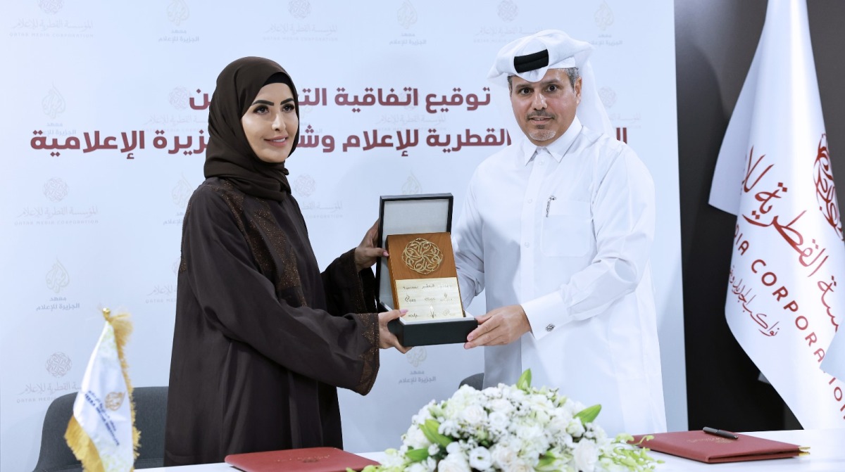 QMC Director of the Office of International Cooperation and Agreements Abdullah Ghanem Al Muhannadi (right) and Director of Al Jazeera Media Institute Eman Al Amri during the agreement signing ceremony yesterday. PIC: Rajan Vadakkemuriyil/The Peninsula