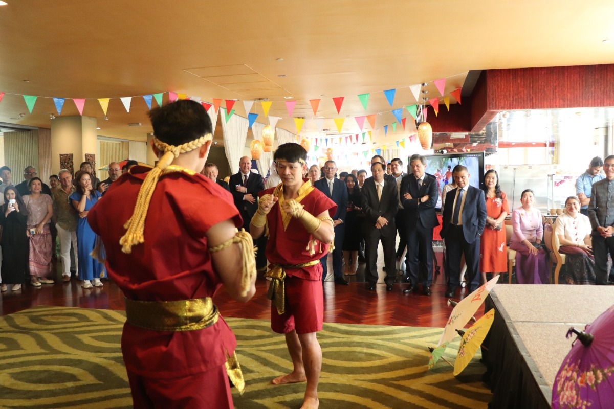 Attendees watch a Muay Thai demonstration at the event.