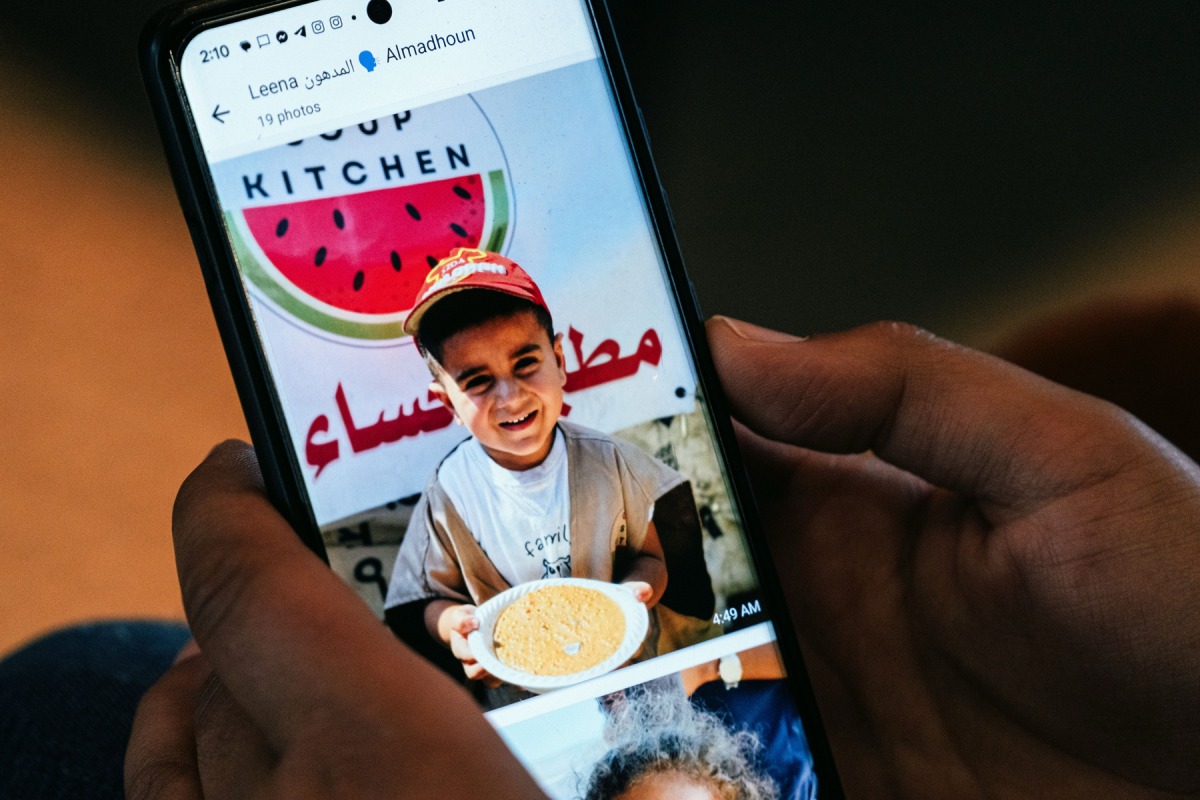 Almadhoun checks out the scene from Gaza using WhatsApp on July 17. Photo credit: Maxine Wallace/The Washington Post
