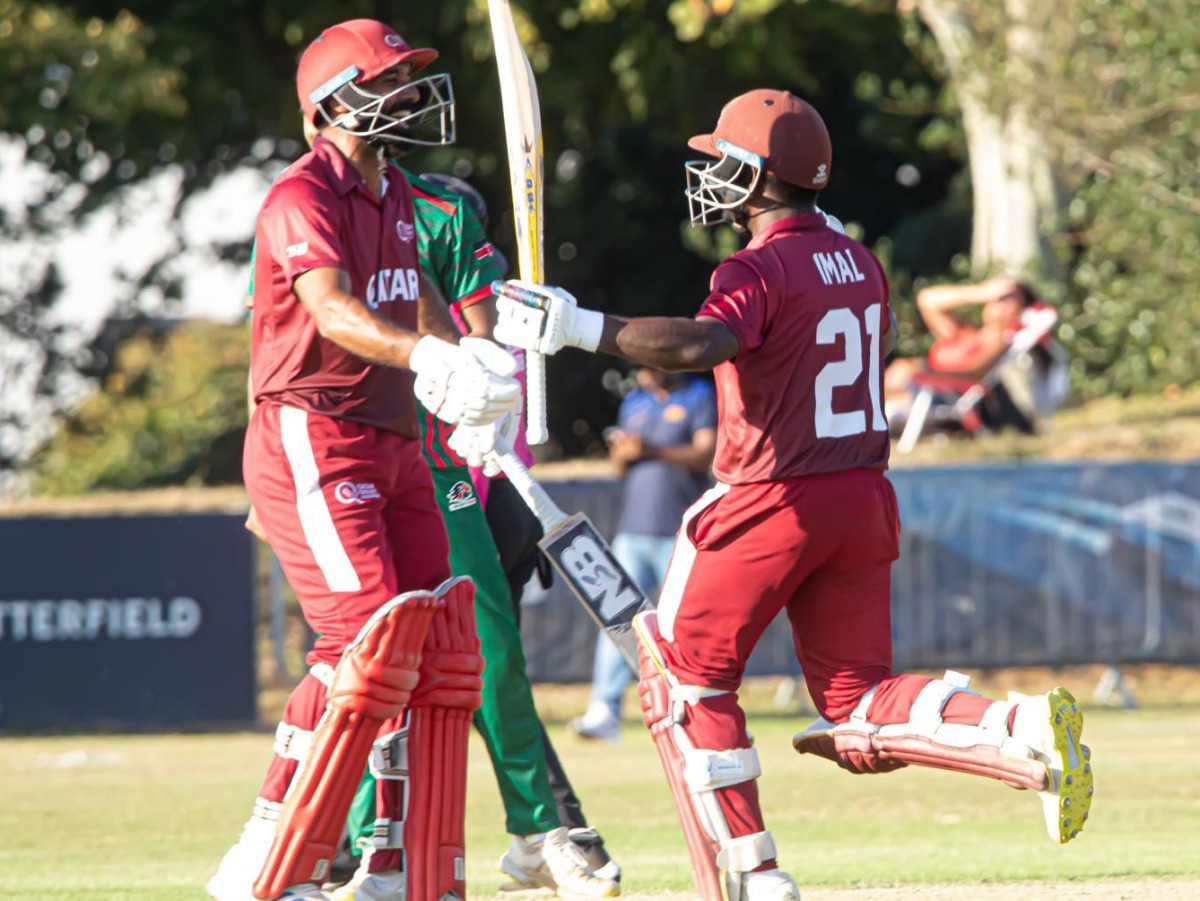 Qatar's Imal Liyanage (right) celebrates after reaching his century.