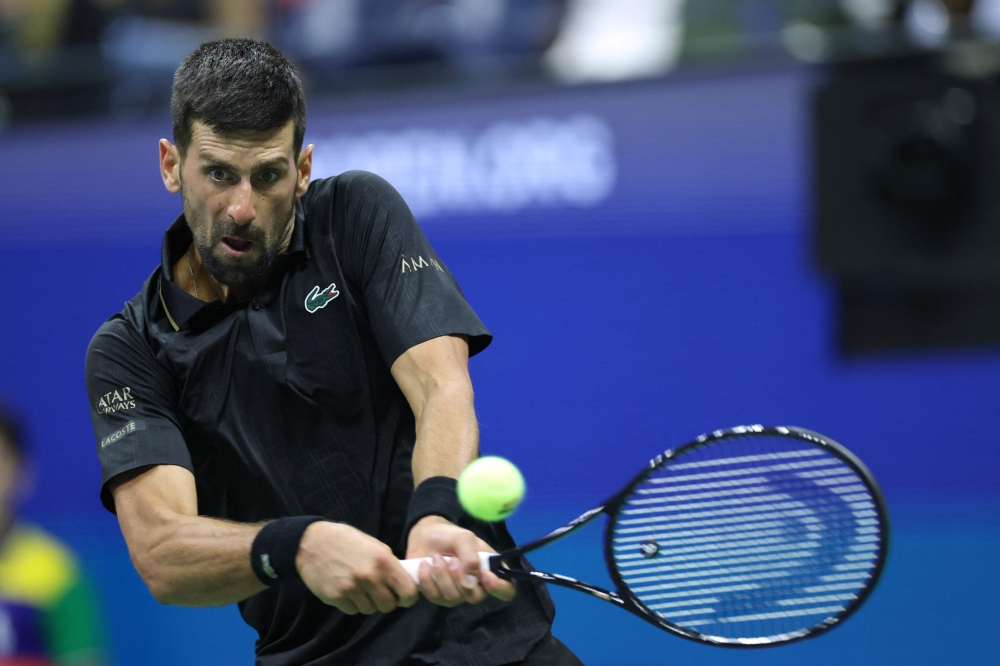 Serbia's Novak Djokovic hits a forehand return to Britain's Cameron Norrie in New York City on August 29, 2025. (Photo by Charly Triballeau / AFP)