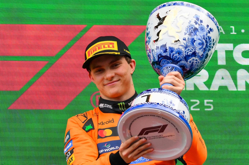 Winner McLaren's Australian driver Oscar Piastri celebrates on the podium following the Formula One Dutch Grand Prix at The Circuit Zandvoort, western Netherlands, on August 31, 2025. (Photo by John Thys / AFP)