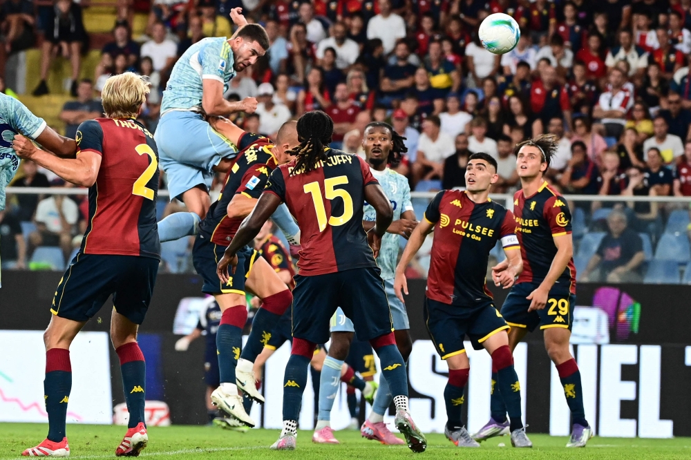Juventus' Serbian forward #9 Dusan Vlahovic scores his team's first goal during the Italian Serie A football match between Genoa and Juventus at the Ferraris Stadium in Genoa, Italy, on August 31, 2025. (Photo by Piero Cruciatti / AFP)
