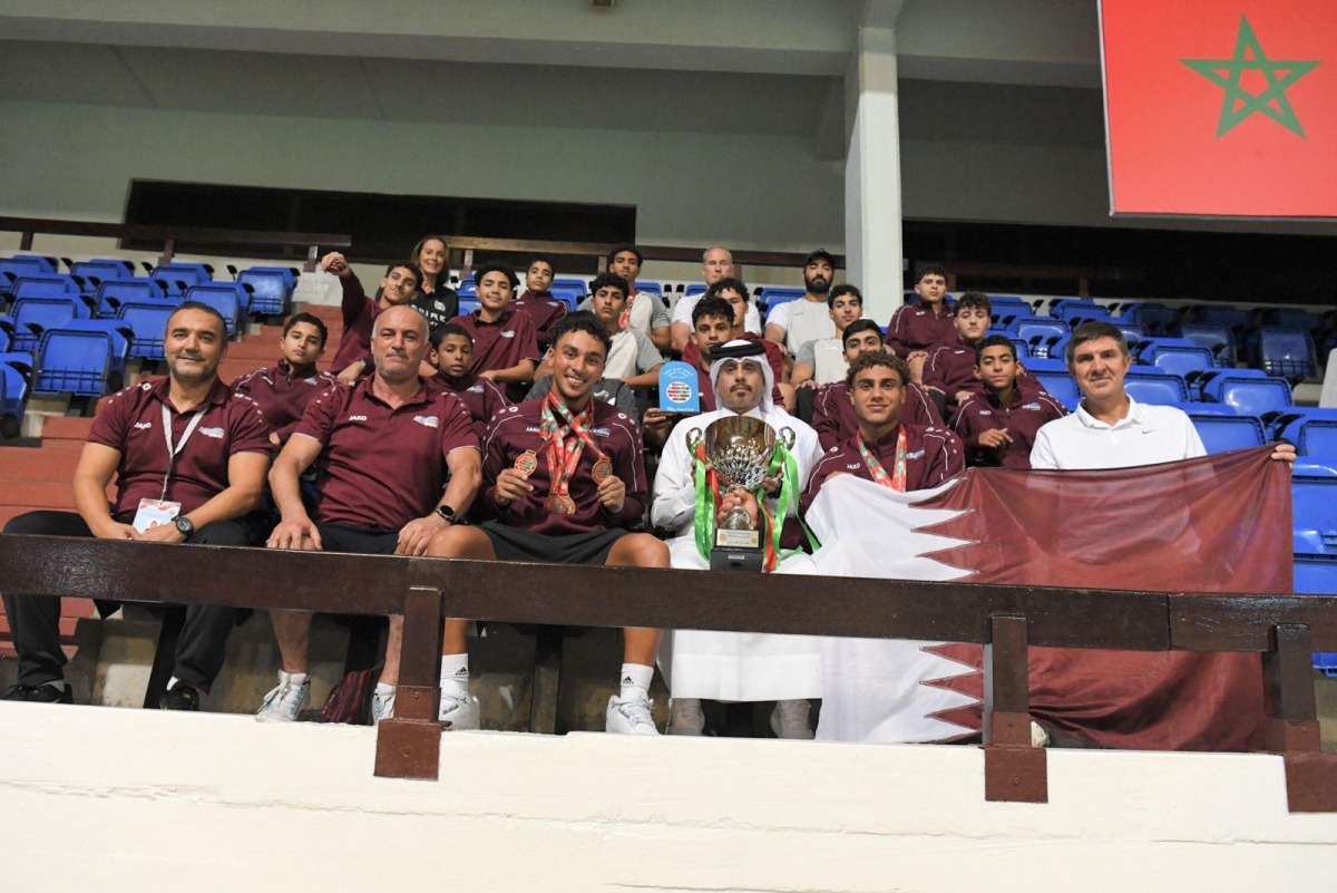 Qatar Swimming Federation President Mubarak bin Ali Al-Nuaimi celebrates with the swimmers and officials.
