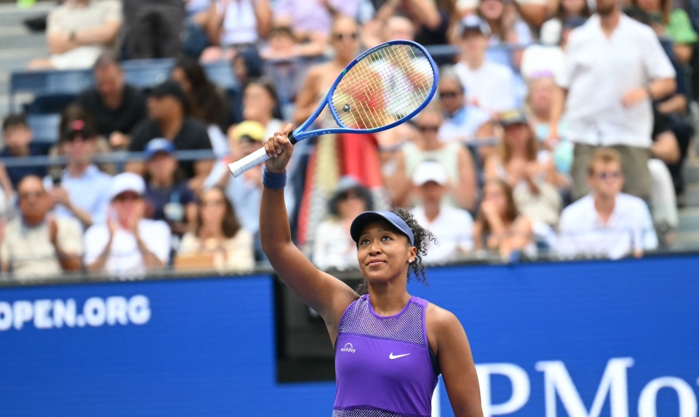 Japan's Naomi Osaka celebrates defeating USA's Coco Gauff during their women's singles round, on September 1, 2025. (Photo by ANGELA WEISS / AFP)