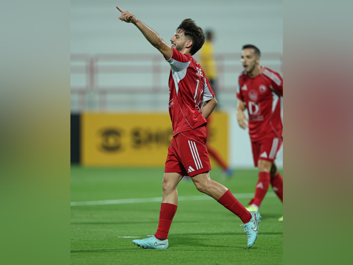 Al Arabi's Salem Reda celebrates after scoring a goal.