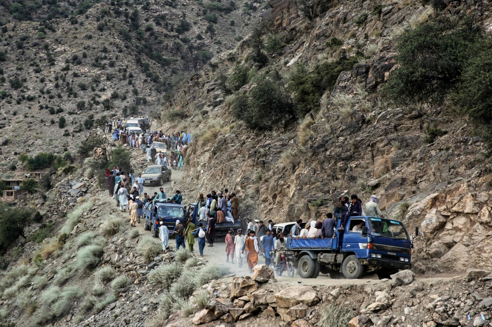 Afghans commute along a hillside, in the aftermath of an earthquake at the Nurgal district of Kunar province on September 3, 2025. (Photo by AFP)