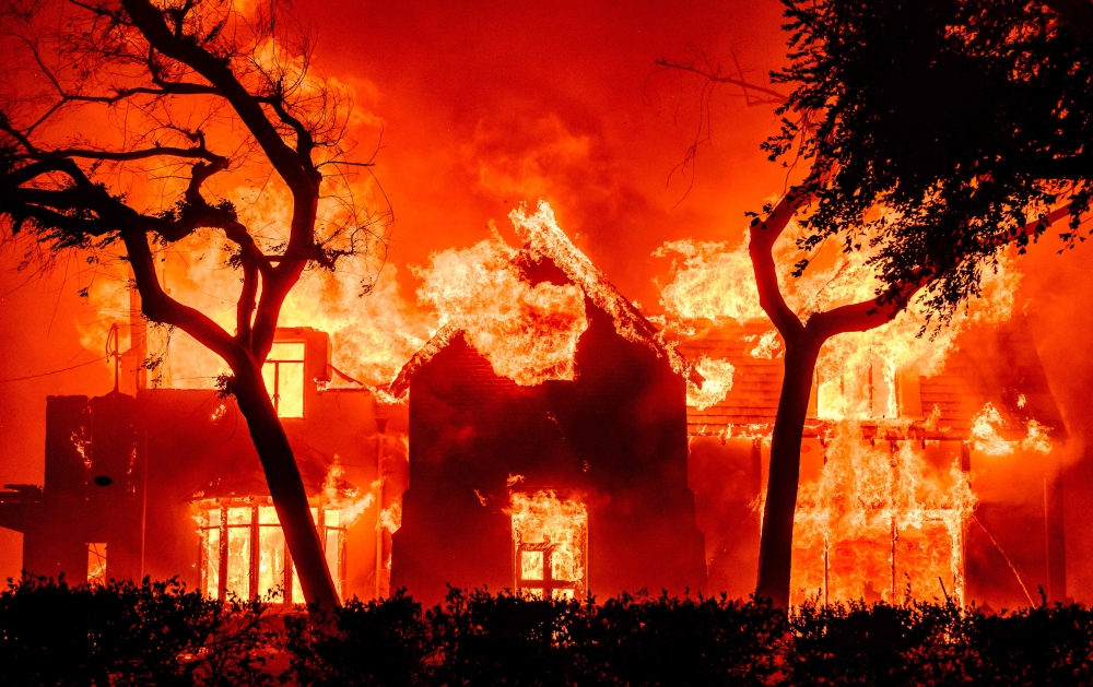 File: A home is engulfed in flames during the Eaton fire in the Altadena area of Los Angeles County, California on January 8, 2025. (Photo by Josh Edelson / AFP)