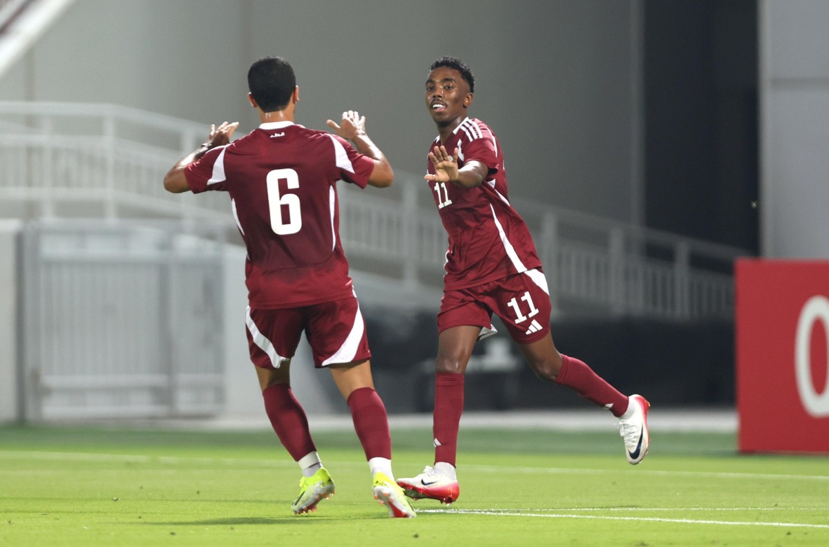 Mohamed Siraj (right) celebrates with a teammate after scoring Qatar's fourth goal.