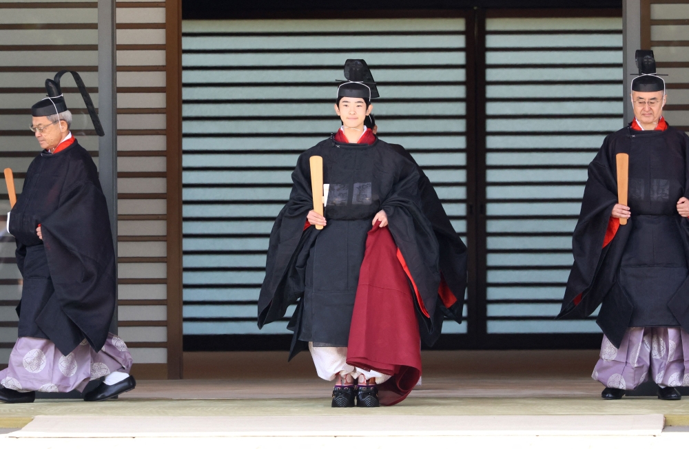 Japanese Prince Hisahito, son of Crown Prince Akishino wearing an ancient ceremonial costume, leaves for a ceremony by a carriage at the Imperial Palace in Tokyo on September 6, 2025. (Photo by Yoshikazu Tsuno / POOL / AFP)