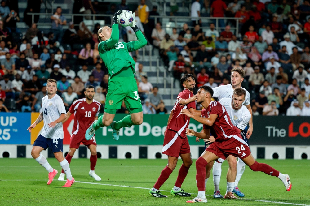Russia's goalkeeper #39 Matvey Safonov secures the ball during the international friendly football match between Qatar and Russia at Jassim Bin Hamad Stadium in Doha on September 7, 2025 (Photo by Karim Jaafar / AFP)
