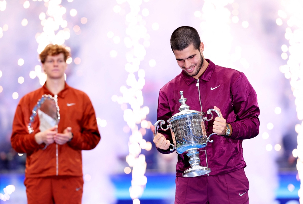 Carlos Alcaraz of Spain poses with his trophy after defeating Jannik Sinner of Italy during their Men's Singles Final match on Day Fifteen of the 2025 US Open at USTA Billie Jean King National Tennis Center on September 07, 2025 in New York City. Clive Brunskill/Getty Images/AFP