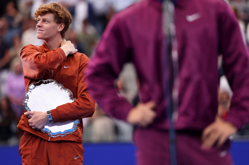 Jannik Sinner of Italy looks on as Carlos Alcaraz of Spain speaks following their Men's Singles Final match on Day Fifteen of the 2025 US Open at USTA Billie Jean King National Tennis Center on September 07, 2025 in New York City. Clive Brunskill/Getty Images/AFP