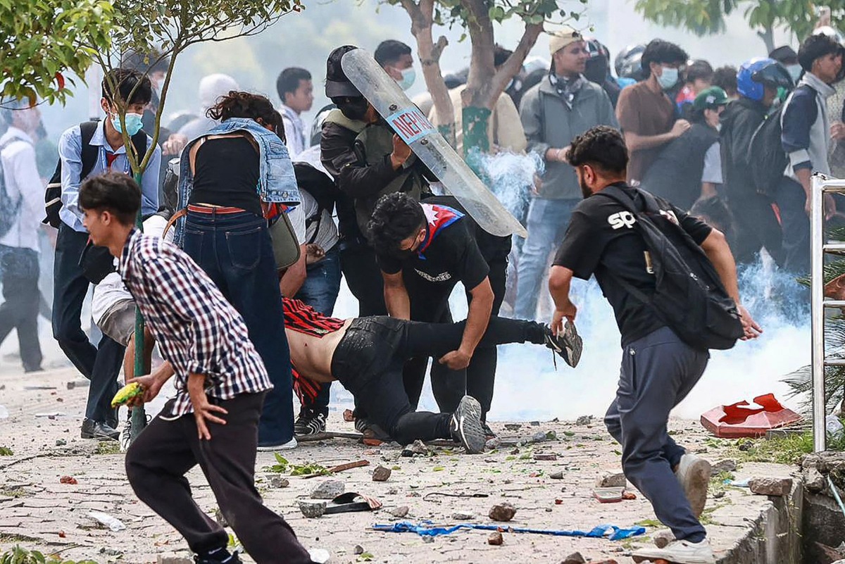 Demonstrators carry an injured victim (C) during a protest outside the Parliament in Kathmandu on September 8, 2025, held to condemn the government over social media prohibitions and corruption. (Photo by Prabin RANABHAT / AFP)

