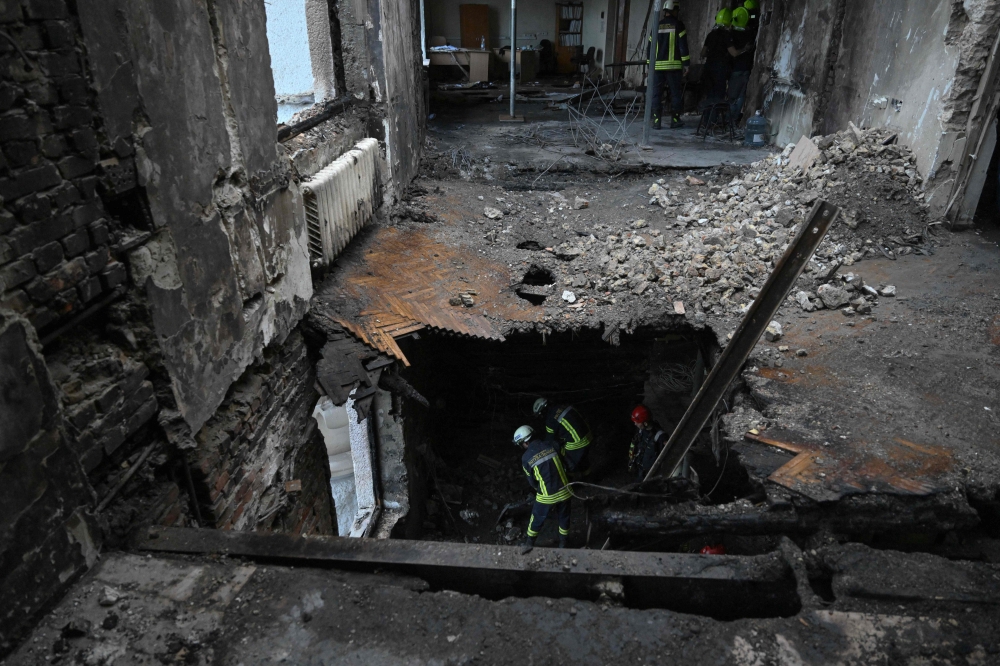 Ukrainian rescuers work on the premises of the Ukrainian government building damaged the previous day during a massive Russian air strike, in Kyiv on September 8, 2025, amid the Russian invasion of Ukraine. (Photo by Genya Savilov / AFP)
