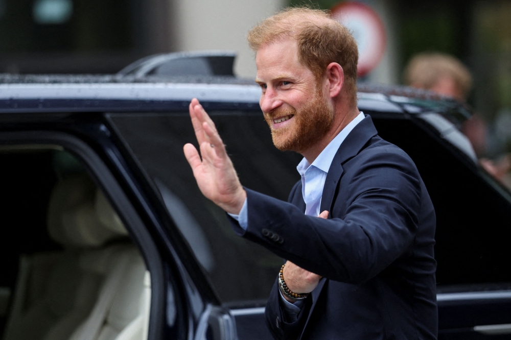 Britain's Prince Harry, Duke of Sussex waves as he departs the Centre for Blast Injury Studies, at the Imperial College in London, on September 10, 2025. (Photo by Suzanne Plunkett / POOL / AFP)
